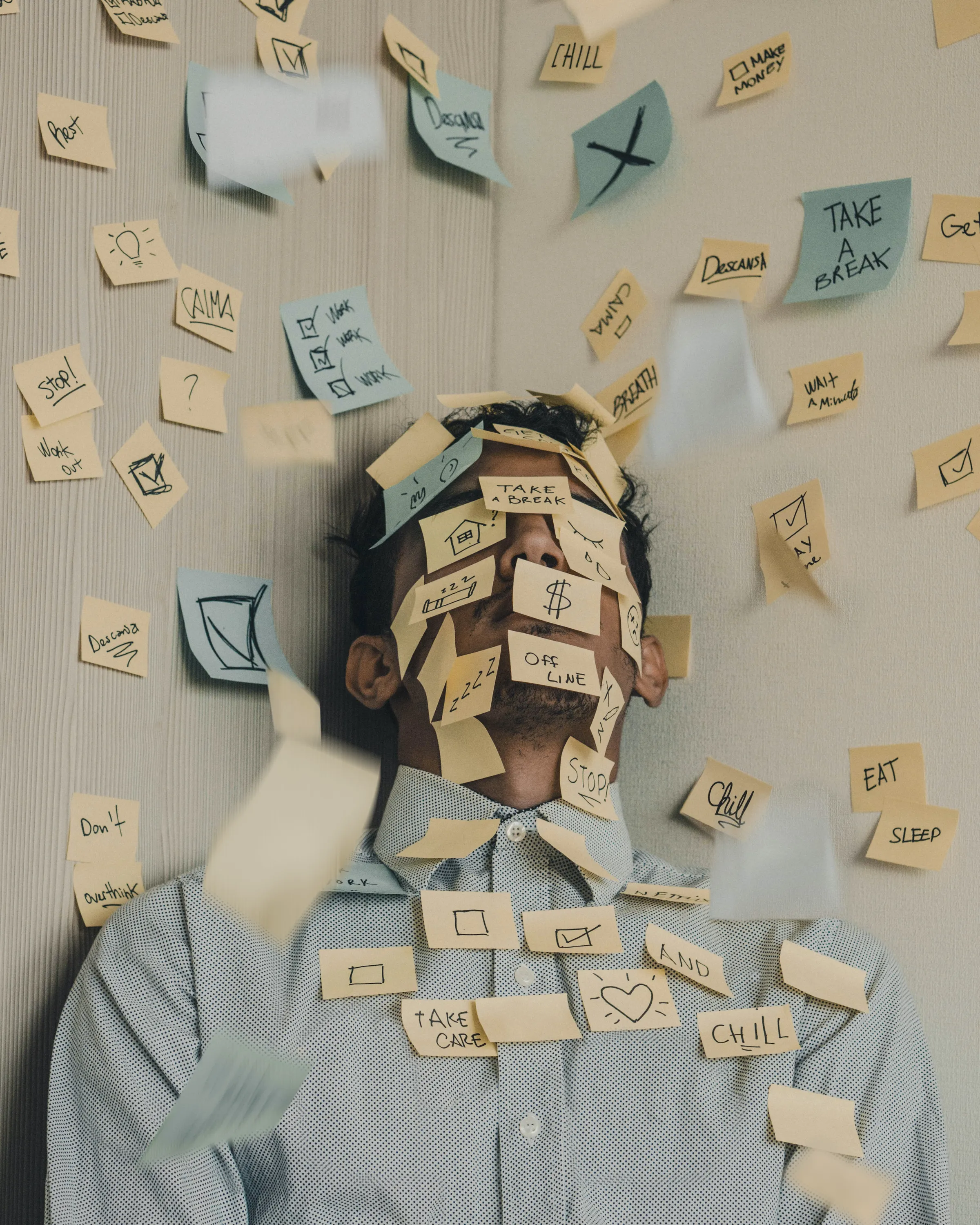 A man whose face is covered in sticky notes
